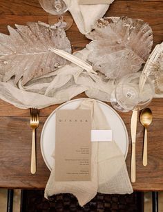 a place setting with napkins, forks and silverware