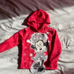 Red, Black And Silver Toddler Hoodie Never Worn. Minnie Mouse Christmas Hoodie: Playful Red Sweatshirt For Fall, Playful Fleece Tops For Winter, Red Long Sleeve Christmas Hoodie, Cute Mickey Mouse Winter Sweatshirt, Cute Winter Mickey Mouse Sweatshirt, Cute Hooded Mickey Mouse Top, Cute Red Sweatshirt For Winter, Cute Red Winter Sweatshirt, Mickey Mouse Hoodie For Winter