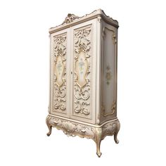 an ornately decorated armoire with gold trimmings and white paint on the doors