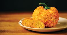 a plate with crackers on it and a pumpkin made out of something else sitting on top of it