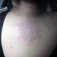 a snowflake on the back of a woman's shoulder