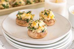 three small appetizers are sitting on top of plates