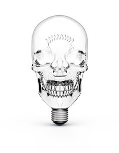 a clear glass skull head light bulb with an open mouth and teeth on the side