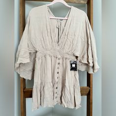 Step Up Your Boho-Chic Style With Our Bohemian Gauze Mini Dress. This Ultra-Feminine Dress Features A Deep V-Neck, Smocked Waistband And Intricate Button Detailing. The Billowy Sleeves And Mini Length Give It A Flirty Edge, While The 100% Rayon Gauze Fabric Keeps It Light And Airy. The Open Back With Tie At Shoulders Adds A Flirtatious Touch, Perfect For Summer Days And Nights. Billowy Sleeves, Ultra Feminine, Gauze Fabric, Feminine Dress, Boho Chic Fashion, Deep V Neck, Summer Days, Step Up, Open Back