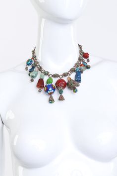 Vintage Chinese Import eclectic bead and cloisonné charm collar necklace. Unique and hard to come by collar necklace featuring painted cloisonné drop beads and stones Silver, agate, coral, jade, orange, scarlet, topaz, quartz Sixteen floral link chain Eleven assortments of seed and bead charm drops with decorative bola ball ends Fold over clasp Silver hardware, acrylic resin Unsigned, made in China Good vintage condition, overall wear, shows signs of wear to beading Measurements Length (End-to-End): 17" Chain Width: 0.47" Largest Charm (Length x Width): 2.5" x 0.98" Weight: 125g Multicolor Dangling Beads Costume Jewelry, Czech Glass Large Beads For Jewelry Making, Artisan Jewelry With Czech Glass And Dangling Beads, Bohemian Jewelry With Large Glass Beads, Unique Czech Glass Jewelry With Dangling Beads, Unique Jewelry With Dangling Round Beads, Unique Beaded Chain Jewelry, Artisan Metal Jewelry With Dangling Beads, Costume Jewelry Necklaces With Czech Glass Polished Beads