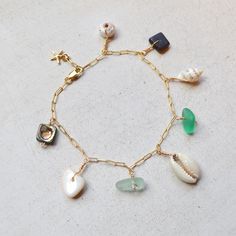 "This beautiful ocean inspired charm bracelet has an assortment of shells and cultured sea glass dangling from a textured cable chain and finished with a tiny gold filled starfish at the end. This bracelet is meant to dangle so I add 1/2\" to the length you order. Please allow for variations in size and shape of shells and sea glass." Gold Charm Bracelet With Starfish For Beach, Beach Ocean-inspired Charm Bracelet, Ocean-inspired Starfish Charm Bracelet For Beach, Bohemian Charm Bracelet For Beach With Lobster Clasp, Bohemian Charm Bracelet For The Beach, Pearl Bangles Gold, Sea Shell Bracelet, Bracelet Ocean, Beachy Bracelets