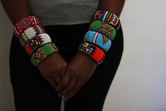 African beaded bracelets, Beaded Bangles, Maasai Wrist bracelets, Beaded jewelry, Christmas gift for her, Mom's gift, Open wearable bracelets These thick bracelets are made by the Maasai women in Kenya.  They are beautiful and can complement any outfit. Circumference: 8 inches  Can fit any wrist size as they are open on end hence making it easy to wear. **If you have a large wrist size, please let us know.  Please select your style in the options shown Shipping fee is for the first item only. Ot Multicolor Bangle With Colorful Beads, Traditional Beaded Bangle Bracelets With Tiny Beads, Traditional Beaded Bangle Bracelet With Tiny Beads, Traditional Tiny Beaded Bangle Bracelets, Traditional Multicolor Stretch Bracelet With Large Beads, Traditional Hand Wrapped Multicolor Beads, Traditional Multicolor Hand-wrapped Beads, Multicolor Beaded Bracelets For Festive Occasions, Multicolor Handmade Beaded Bracelets For Festive Occasions