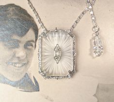 Offering an exquisite EXTREMELY RARE designer signed circa 1920s - 1930s era Art Deco/Edwardian rhodium plated camphor glass and crystal rhinestone dress/fur clip that can also be worn as a pendant necklace.  The perfect "Something Old" Bridal shower gift!  This unusual treasure will as look fantastic with a pair of jeans and a tee as it will with a Bridal gown. It's getting more and more difficult to find these Art Deco camphor pieces but to find one in dress clip form is so unusual.  The dress Camphor Glass Jewelry, Black Hills Gold Jewelry, Vintage Wedding Jewelry, Filigree Necklaces, Vaseline Glass, Black Hills Gold, Glass Jewellery, Sparkly Things, White Gold Necklaces