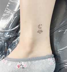 a small tattoo on the ankle of a woman