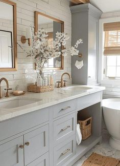 a white bathroom with two sinks and a tub