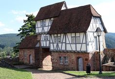 an old house with two stories and a brown roof