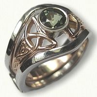 a silver ring with a green stone in the center