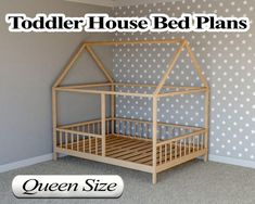 a wooden bed frame for a toddler's house with stars on the wall