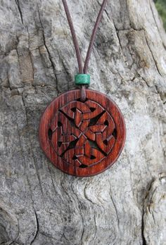 This very unique hand-carved Celtic knot necklace will be made for you, or a loved one, in my studio on the West of Ireland. This complex Celtic knot necklace features an off-cut of bubinga rosewood, recycled from musical instruments constructed by a local luthier. As a musician myself, I take enormous satisfaction in creating a piece of jewellery whose inherent wood has previously featured in a beautiful hand-made guitar. Also, part of rosewood's attractiveness is its durability and ability to Brown Carved Round Pendant Necklace, Traditional Mahogany Jewelry As Gift, Traditional Mahogany Jewelry For Gifts, Artisan Carved Medallion Necklace, Traditional Handmade Mahogany Jewelry, Celtic Infinity Knot, Irish Knot, Celtic Jewellery, Celtic Knot Necklace