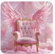 a pink and gold chair with angel wings on the back in front of a backdrop