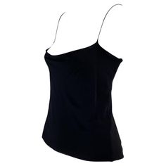 Presenting a sensual Gucci tank top designed by Tom Ford. This uniquely shaped tank top features a cowl neck and spaghetti straps with a similar cowl draping to expose the back. This shirt is not your average tank top; it was designed for the Spring/Summer 1997 collection and is the perfect chic elevation for the standard tank. Approximate measurements: Size - IT42 Bust: 30” - 38” Waist: 30” Shoulder to hem: 22” Sleeveless Evening Tops With Built-in Bra, Cami Top With Built-in Bra For Evening, Elegant Sleeveless Gucci Top, Silk Cami Top With Built-in Bra, Gucci Black Top For Party, Sleek Fitted Top With Tank Straps, Sleek Spaghetti Strap Top For Night Out, Chic Fitted Cowl Neck Tank Top, Fitted Camisole Tank Top For Party