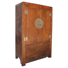 an old wooden cabinet with two brass knobs on the front and one door open