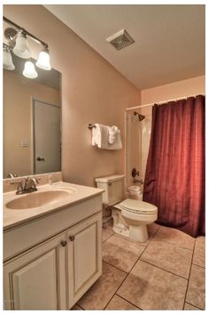 a bathroom with a sink, toilet and shower