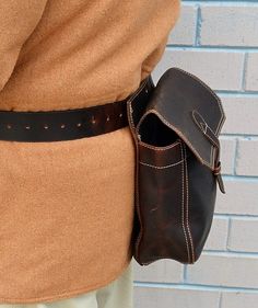 "The pouch is oil tanned leather bird bag includes leather 1 3/4\" inch wide belt with 1 3/4\" solid brass belt buckle. The belt fits waist sizes 34\" - 46\". Bag is attached with Chicago screws allowing complete versatility in removing each pouch to your liking. The center bird bag is lined with 100% nylon fabric for ease of cleaning. Material: Oil Tanned Leather Hardware: Antique Brass Outside Dimensions: Bird Bag - 9.5\" W x 9 1/4 \" H x 3\" D Shells Bag - 8.5\" W x 8 \" H x 3\" D Belt - 46 \ Classic Leather Belt Bag With Belt Loops, Leather Belt Buckles With Removable Belt For Everyday Use, Leather Belt Buckle With Removable Belt For Everyday Use, Everyday Leather Belts With Brass Hardware, Brown Belt With Brass Hardware For Everyday, Vintage Belts And Suspenders With Removable Belt, Vintage Belts And Suspenders For Everyday Use, Leather Belt Buckles With Brass Buckle For Everyday, Vintage Belt Bag With Belt Loops For Everyday Use