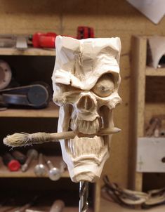 a sculpture of a skull with a toothbrush in it's mouth