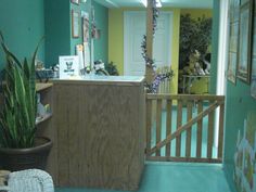 the hallway is decorated in pastel colors and features a wooden bar, potted plants, and pictures on the wall