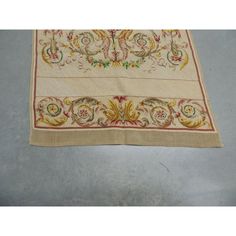 an embroidered table runner with floral designs on it