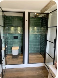 a bathroom with two glass doors and a toilet