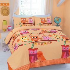 an orange and pink bed with owls on it