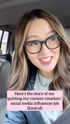 a woman with glasses sitting in the back seat of a car and looking at the camera