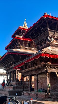 an ornate building with red and white awnings