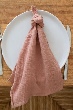 a white plate topped with a pink napkin