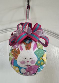 an ornament hanging from a door with a bunny on it