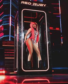 a woman standing in front of a red ruby sign