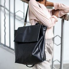 "100% Handmade Gorgeous and practical Black leather backpack / shoulder bag in a unique geometric cut with asymmetric details . This bag has a minimalistic and timeless form which makes it functional as a tote as well as backpack. It is made for a long day out of the house as well as a night out where you can carry your essentials plus laptop, a sweater, sunglasses etc... Fully lined with black strong cotton fabric which I divide to two large interior (one for laptop), large zip pocket, and a le Leather Laptop Tote, Small Leather Backpack, Soft Leather Backpack, Laptop Backpack Women, Leather Hip Bag, Large Leather Bag, Leather Laptop Backpack, Brown Leather Backpack, Backpack Laptop