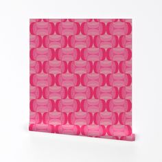 a pink paper with circles on it sitting on top of a white table next to a wall