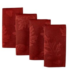 four red napkins with leaves on them are lined up against a white background,