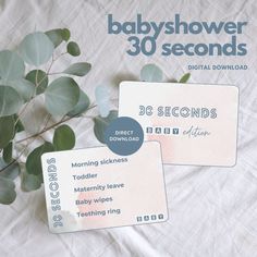 two babyshower 30 seconds cards sitting on top of a bed next to a plant