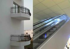 an escalator in a building with two balconies next to each other