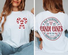 Front And Back Candy Canes Shirt - Gift For Christmas - Christmas Shirt - Christmas Party Shirt - Christmas Candy Shirt - Xmas Family Shirt How can I order? 1️) Please review all the information provided before placing an order 2️) Select the shirt type and size. 3️) Select the color of the shirt using the following options. 4️) Please add the vinyl color (white or black) in the optional message section of the order. 5️) Need more Items? Add the current item in the cart. And If you like to add m Candy Cane Vinyl Shirt, Christmas Shirt Cricut, Pre-shrunk White Christmas Shirt, White Pre-shrunk Christmas Tops, Casual Pre-shrunk Christmas Shirt, Candy Cane Shirts For Kids, Candy Cane Shirt Ideas, Cute Christmas Shirts Vinyl, Candy Cane Outfit