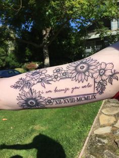 a person with a tattoo on their arm that says, i love you and sunflowers