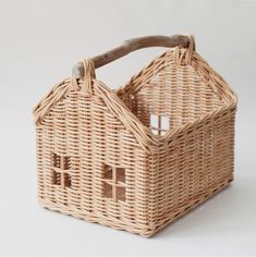 a wicker basket with a house on it