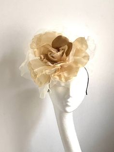 Large gold flower hat This amazing large gold flower hat is made from organza and velvet fabric. The hat sits on the black fabric-covered headband to which I attached small round sinamay base and  a comb so it will sit steadily on your hair. A large gold flower hat will be an amazing accessory to compliment your outfit. It will fit the average head size. You can wear this amazing hat at the wedding, Christening, Horse races, and any other special occasion. Enjoy and please have a look in my shop Elegant Cream Flower Fascinator, Gold Curved Brim Fascinator For Spring, Gold Costume Hats For Spring Wedding, Gold Costume Hats And Headpieces For Spring Wedding, Gold Wedding Headpiece With Round Crown, Gold Structured Crown Hat For Kentucky Derby, Flower Hat For Royal Ascot Party, Flower Headpieces For Royal Ascot Party, Gold Mini Hat For Spring Evenings