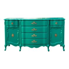 a green dresser with gold handles on it's sides and drawers, against a white background