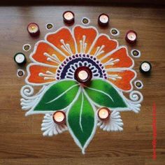 a colorful rang art design with candles on the floor