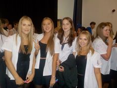 a group of young women standing next to each other