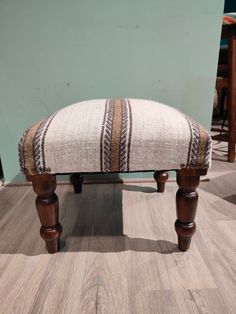 a wooden bench sitting on top of a hard wood floor