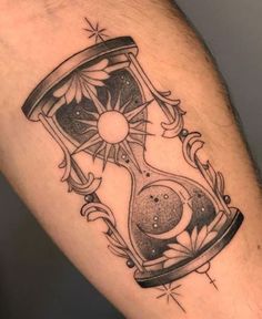 a tattoo with an hourglass on the arm