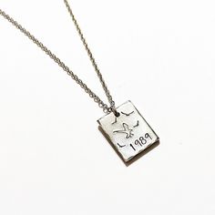 "A beautiful dainty 3/4\" x 1/2\" rectangle pewter pendant has been hand stamped and finished with a stainless steel 18\" chain. Perfect for the music lover in your life! All items are stamped by hand! Some slight variances in the pattern may occur as a result adding to the uniqueness of the piece. Are you looking for something custom? Let me know! I'd be happy to try and accommodate your request! A different word, lyric, message or a name can easily be added to the design to make the perfect cu Rectangular Engraved Charm Necklaces For Anniversary, Sterling Silver Rectangular Charm Necklace For Anniversary, Engraved Rectangular Charm Necklaces For Anniversary, Rectangular Sterling Silver Charm Necklace For Anniversary, Rectangular Silver Charm Necklace For Anniversary, Stamped Rectangular Pendant Jewelry For Anniversary, Rectangular Hand Stamped Jewelry For Anniversary, Hand Stamped Rectangular Jewelry For Anniversary, Hand Stamped Rectangular Necklaces For Mother's Day