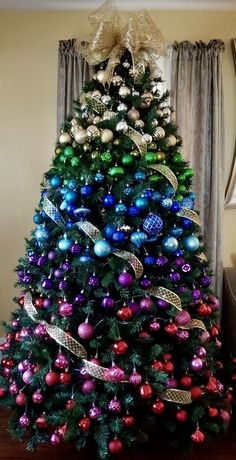 a christmas tree decorated with ornaments and ribbons