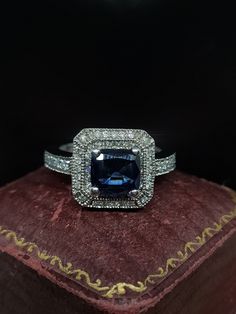 Here we have an incredible high quality statement cocktail ring featuring a central sparkling blue sapphire with diamond encrusted mount fashioned from 14ct white gold. The ring is inspired by the art deco era with a high quality finish and solid weight.  UK size - M US size - 6.25  Weight approx - 5.90 grams  Message me any questions Classic Blue Halo Ring For Formal Occasions, Blue Rings With Diamond Accents For Anniversary, Hallmarked Sapphire Diamond Ring For Formal Occasions, Classic Blue Sapphire Ring With Diamond Accents, Blue Sapphire Ring With Diamond Accents For Anniversary, Blue Diamond Ring With Accents For Anniversary, Formal Sapphire Ring With Diamond, Dazzling Sapphire Ring With Halo Setting For Formal Occasions, Formal Sapphire Topaz Ring With Diamond Accents